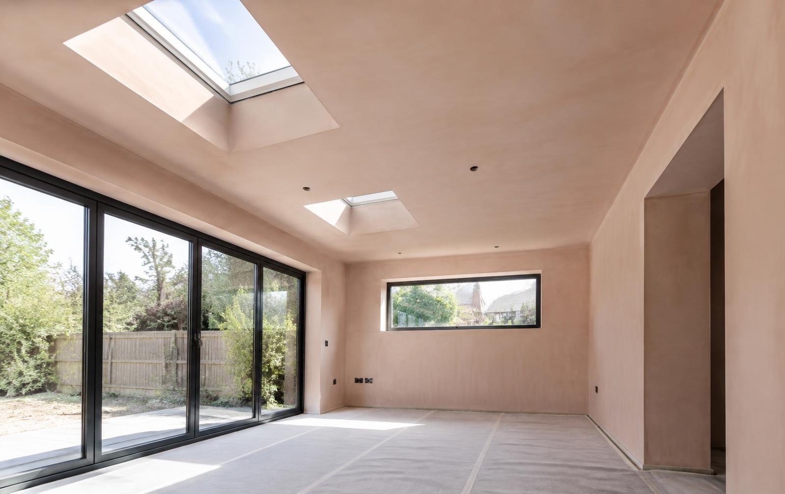 Freshly plastered extension with smooth ceiling and skylight reveals